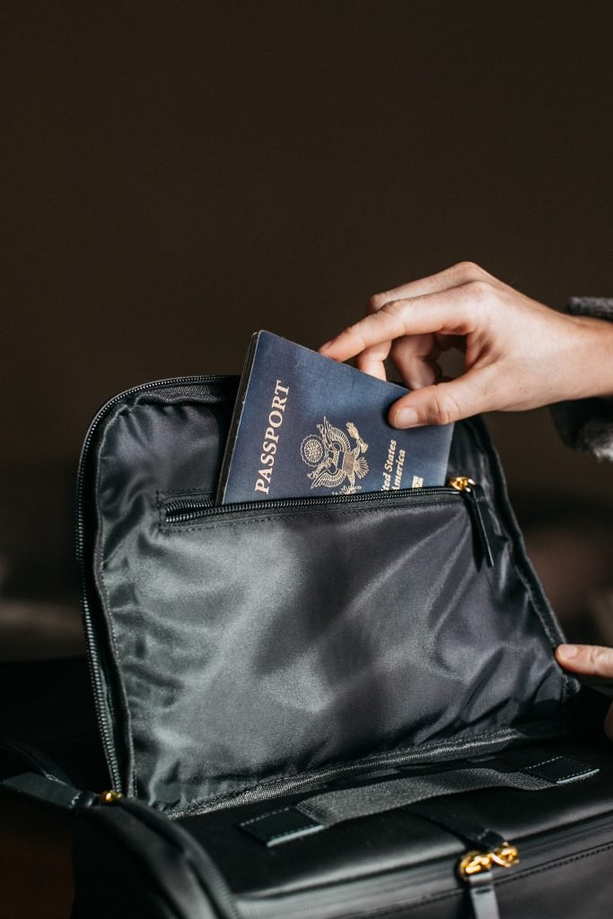 person putting a passport on bag 842961